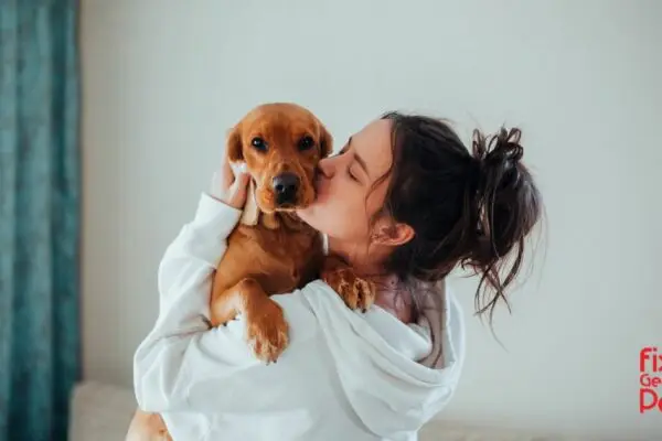 Woman hugging her companion animal.