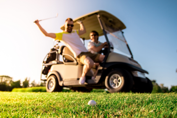 Excited golfers riding golf cart