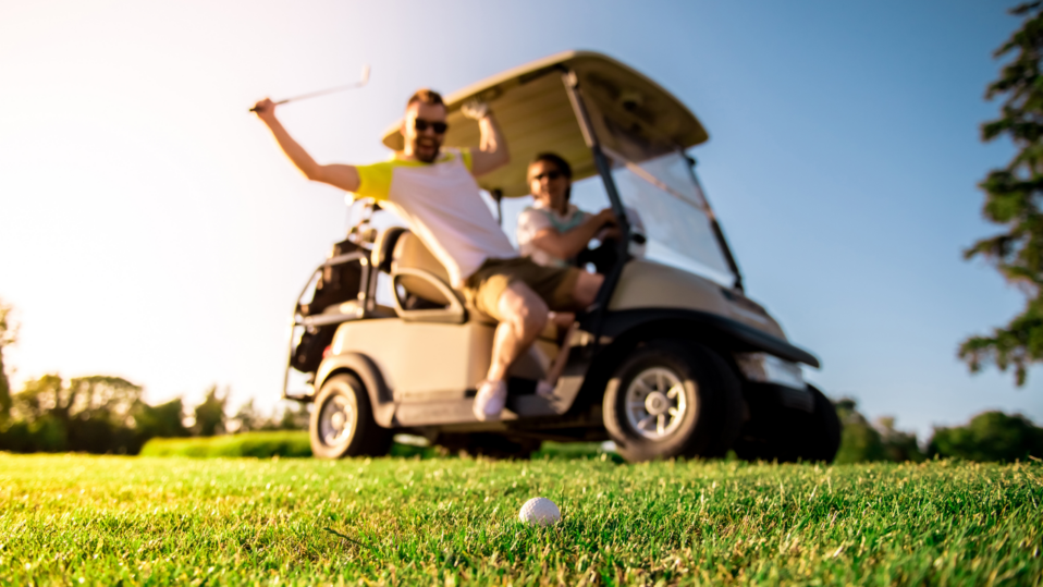 Excited golfers riding golf cart