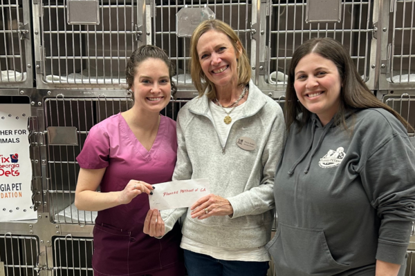 Fix Georgia Pets’ Executive Director presents Planned Pethood of Georgia with a grant for their spay neuter program
