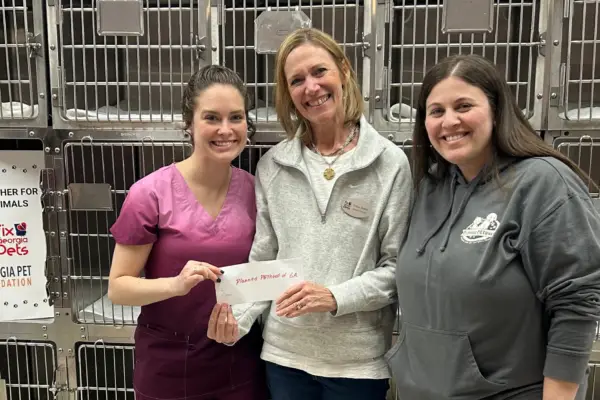 Fix Georgia Pets’ Executive Director presents Planned Pethood of Georgia with a grant for their spay neuter program